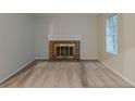 Cozy living room featuring a brick fireplace with a white mantel, neutral walls, and carpet at 4634 Garden Hills Dr, Stone Mountain, GA 30083