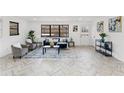 Spacious living room with modern decor, herringbone flooring, and natural light at 1066 Cleavemark Dr, Clarkston, GA 30021