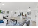 Open-concept living space with modern furnishings, including a kitchen island and dining area at 1066 Cleavemark Dr, Clarkston, GA 30021
