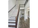 Elegant foyer with hardwood floors, staircase, and iron railing at 195 Silvercrest Dr, Acworth, GA 30101