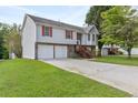 Charming two-story home with a two-car garage, stone accents, and ample yard space at 946 Redan Trce, Stone Mountain, GA 30088