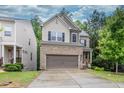 Two-story home with a brick and siding exterior, attached garage, and well-maintained lawn at 118 Hardy Water Dr, Lawrenceville, GA 30045