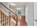 Carpeted staircase with wood railings and metal balusters leading to the upper level at 118 Hardy Water Dr, Lawrenceville, GA 30045