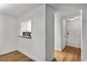 Light and airy hallway with crisp white trim and updated wood floors throughout at 1603 Cumberland Ct, Smyrna, GA 30080