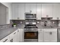 Modern kitchen boasts stainless steel appliances, gray countertops, and sleek cabinets at 1603 Cumberland Ct, Smyrna, GA 30080