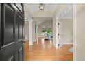 Inviting foyer with hardwood floors, high ceilings, and an arched window view at 411 Hickory Fairway Ct, Woodstock, GA 30188