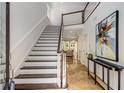 Bright foyer with hardwood floors, staircase, and view into the living space at 1078 Shady Valley Ne Pl, Atlanta, GA 30324