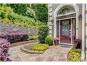 Landscaped front entrance with a stone pathway and a charming front door at 1078 Shady Valley Ne Pl, Atlanta, GA 30324