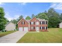 Charming two-story brick home with a well-maintained lawn and a two-car garage at 1486 Rogers Crossing Dr, Lithonia, GA 30058