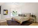 Cozy bedroom with a neutral palette, natural light, plush bedding, and a textured rug at 77 Delmont Ne Dr, Atlanta, GA 30305