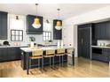 Modern kitchen with gray cabinets, marble countertops, and brass pendant lighting above the island at 77 Delmont Ne Dr, Atlanta, GA 30305