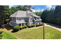 Beautifully landscaped lawn and garden highlighting the exterior and roof of this two-story home at 1501 Laurelhill Drive Southwest Dr, Lawrenceville, GA 30044