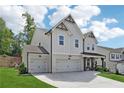 Beautifully designed home featuring brick accents, a spacious three-car garage, and a well-maintained lawn at 2445 Hidden Creek Rd, Kennesaw, GA 30152