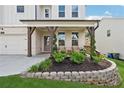 Charming front porch featuring stone accents, seating, and beautiful landscaping for a welcoming entrance at 2445 Hidden Creek Rd, Kennesaw, GA 30152