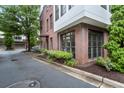 Exterior of a brick condominium with green landscaping and mature trees at 1300 Dekalb Ne Ave # 711, Atlanta, GA 30307