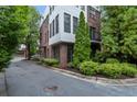 Landscaped exterior view of a brick and white condo building with street parking at 1300 Dekalb Ne Ave # 711, Atlanta, GA 30307