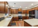 Spacious kitchen with stainless steel appliances, wooden cabinets, and a central island at 3395 The Commons Dr, Cumming, GA 30041