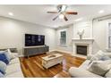 Bright living room with hardwood floors, fireplace, and modern furniture at 3395 The Commons Dr, Cumming, GA 30041