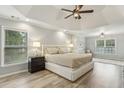 Large main bedroom features tray ceilings, neutral colors, and lots of natural light at 3395 The Commons Dr, Cumming, GA 30041