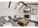 Cozy living room with exposed wood beams, a fireplace, and built-in shelving at 4733 Eidson Road, Dunwoody, GA 30360