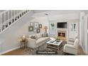 Bright living room with fireplace, a cozy couch, and neutral decor, perfect for relaxation and entertaining at 484 Culberson Sw St, Atlanta, GA 30310