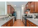Functional kitchen features wooden cabinetry, stainless steel appliances, and generous counter space for meal preparation at 768 Nehemiah Sw Ln, Atlanta, GA 30331