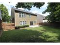A spacious, grassy backyard featuring a wood fence and a small concrete patio at 942 Idlewood Dr, Canton, GA 30115