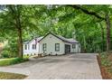 Home exterior with extended driveway and beautiful green trees at 3924 Ashford Dunwoody Road Northeast Ne Rd, Atlanta, GA 30319