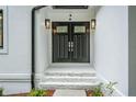 Close up of the stately, black, double front door with a stone path at 3924 Ashford Dunwoody Road Northeast Ne Rd, Atlanta, GA 30319