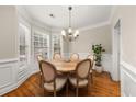 Bright dining room featuring a bay window, hardwood floors, and a charming chandelier at 3937 Covey Flush Sw Ct # 25, Smyrna, GA 30082