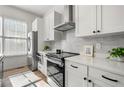 Contemporary kitchen with white countertops, stainless steel appliances, and stylish backsplash at 720 Perch Pl, Atlanta, GA 30312