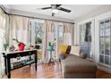 Bright sunroom with a ceiling fan, large windows, and a comfortable chaise lounge at 406 Country Park Se Dr, Smyrna, GA 30080