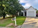 Inviting single-Gathering home featuring a well-kept lawn and attached garage at 10600 Pine Forest Ln, Jonesboro, GA 30238