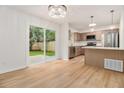 Open kitchen and dining area featuring stainless steel appliances and sliding glass doors to the backyard at 657 Stratford Green Way, Avondale Estates, GA 30002