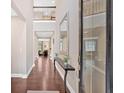 Elegant entryway with hardwood floors, a high ceiling, a decorative mirror, and a view of the living spaces at 12 Pine St, Roswell, GA 30075