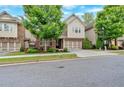 Charming two-story home featuring brick and siding, a well-manicured lawn, and an attached two-car garage at 12 Pine St, Roswell, GA 30075
