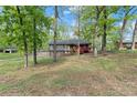 Split-level home with stone foundation, charming red front porch, surrounded by trees at 230 Oakridge Se Dr, Cartersville, GA 30121