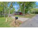 Street view of a split-level home with a mailbox, fire hydrant, and mature trees at 230 Oakridge Se Dr, Cartersville, GA 30121