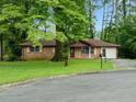 Traditional brick home with well-maintained lawn, surrounded by lush trees at 3047 Hudson Ct, Decatur, GA 30033