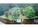 Secluded home on wooded lot with private lake access and a charming dock at 3140 Thoreau Ct, Loganville, GA 30052