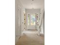 Bright entryway features white walls, light hardwood floors and a craftsman-style door with sidelights at 1115 Ralph Ne Rd, Atlanta, GA 30324