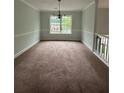 Inviting dining room featuring neutral walls, carpet and a large window for natural light at 4069 Savannah Ridge Ct, Loganville, GA 30052