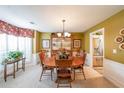 Formal dining room featuring wood table, chandelier, and wainscoting detail at 626 Dahoma Trail Trl, Woodstock, GA 30188