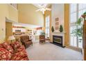 Bright living room with tall ceilings, large windows, fireplace, and comfortable seating area at 626 Dahoma Trail Trl, Woodstock, GA 30188