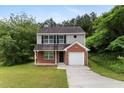 Charming two-story home with brick and vinyl siding and attached one car garage at 3915 Cypress Pointe Dr, Union City, GA 30291