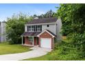 Charming two-story home with brick and vinyl siding and attached one car garage at 3915 Cypress Pointe Dr, Union City, GA 30291
