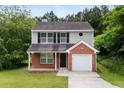 Charming two-story home with brick and vinyl siding and attached one car garage at 3915 Cypress Pointe Dr, Union City, GA 30291
