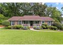 Well-maintained home with a covered front porch and manicured shrubbery at 621 Windgrove Se Rd, Marietta, GA 30067