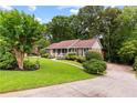 Lovely front yard, a lush green lawn, mature trees, and an inviting home at 621 Windgrove Se Rd, Marietta, GA 30067