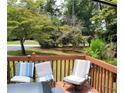 Relaxing outdoor deck with comfortable seating and views of the surrounding trees and neighborhood at 938 Lost Valley Drive Southeast Se Dr, Conyers, GA 30094